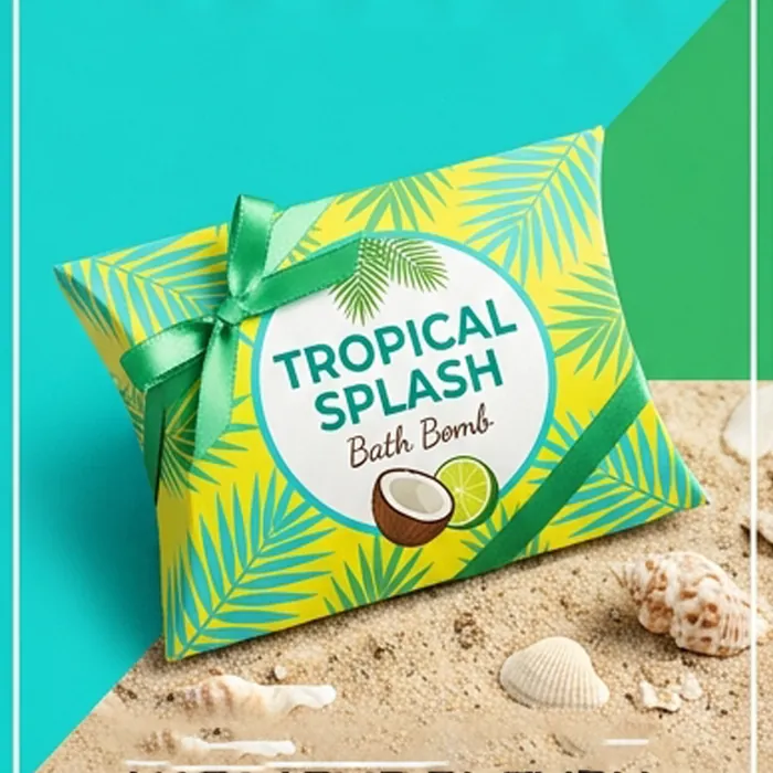 Bright tropical bath bomb pillow box with a green bow on sand and shells