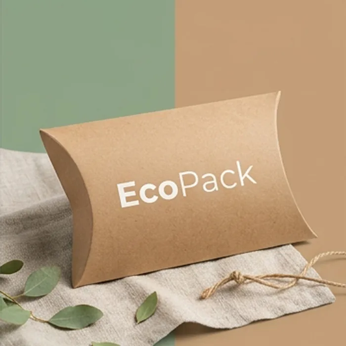 Kraft-toned cardboard pillow box printed with an eco pack wordmark on linen