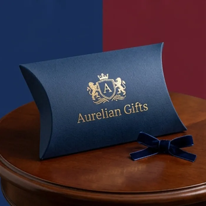 Navy cardboard pillow box with a gold crest on a polished wooden table