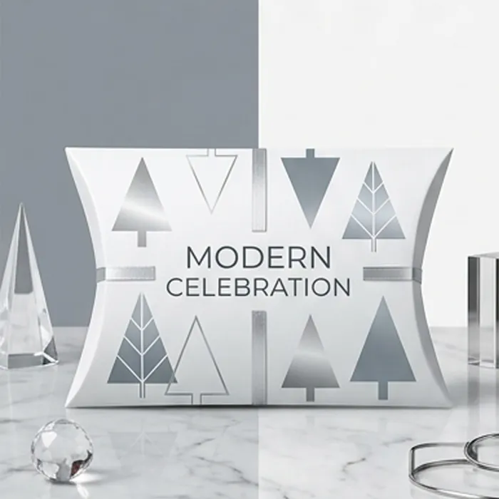 White and silver Christmas pillow box printed with stylized trees