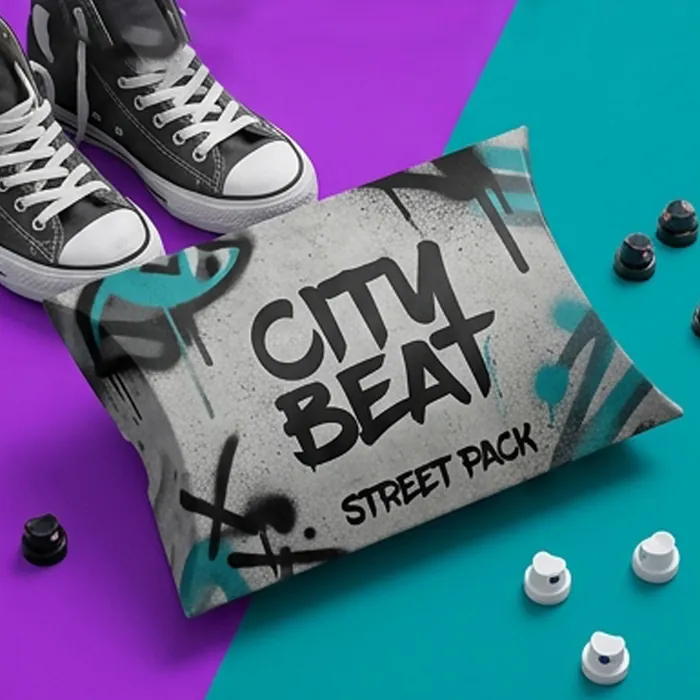 Gray graffiti-printed corrugated pillow box beside a pair of sneakers