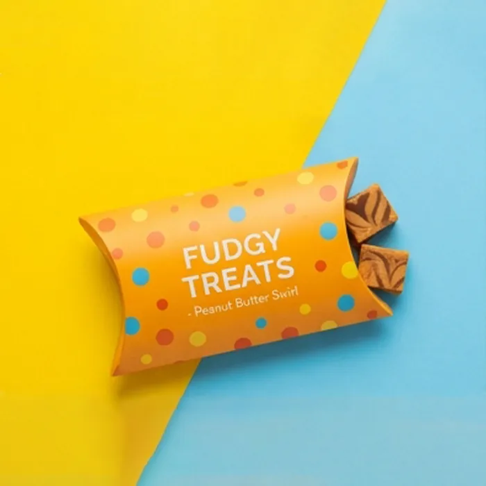 Orange fudge pillow box with a bold wordmark and caramel popcorn alongside