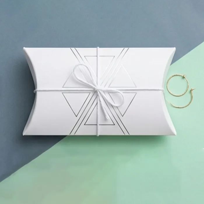 Medium white pillow box with a fine white ribbon on a mint background