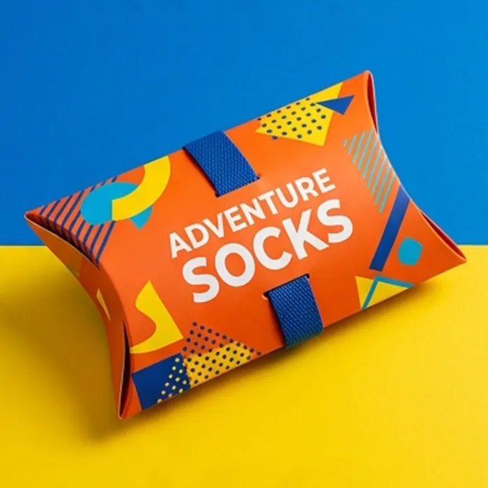 Bright orange sock pillow box with an adventure socks print